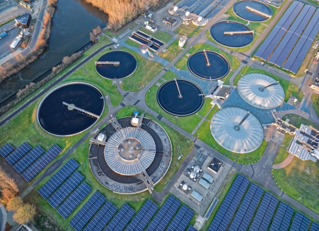 Aerial view of modern wastewater treatment plant with solar panels